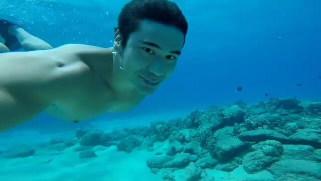 Diving barefaced underwater with hard nipples