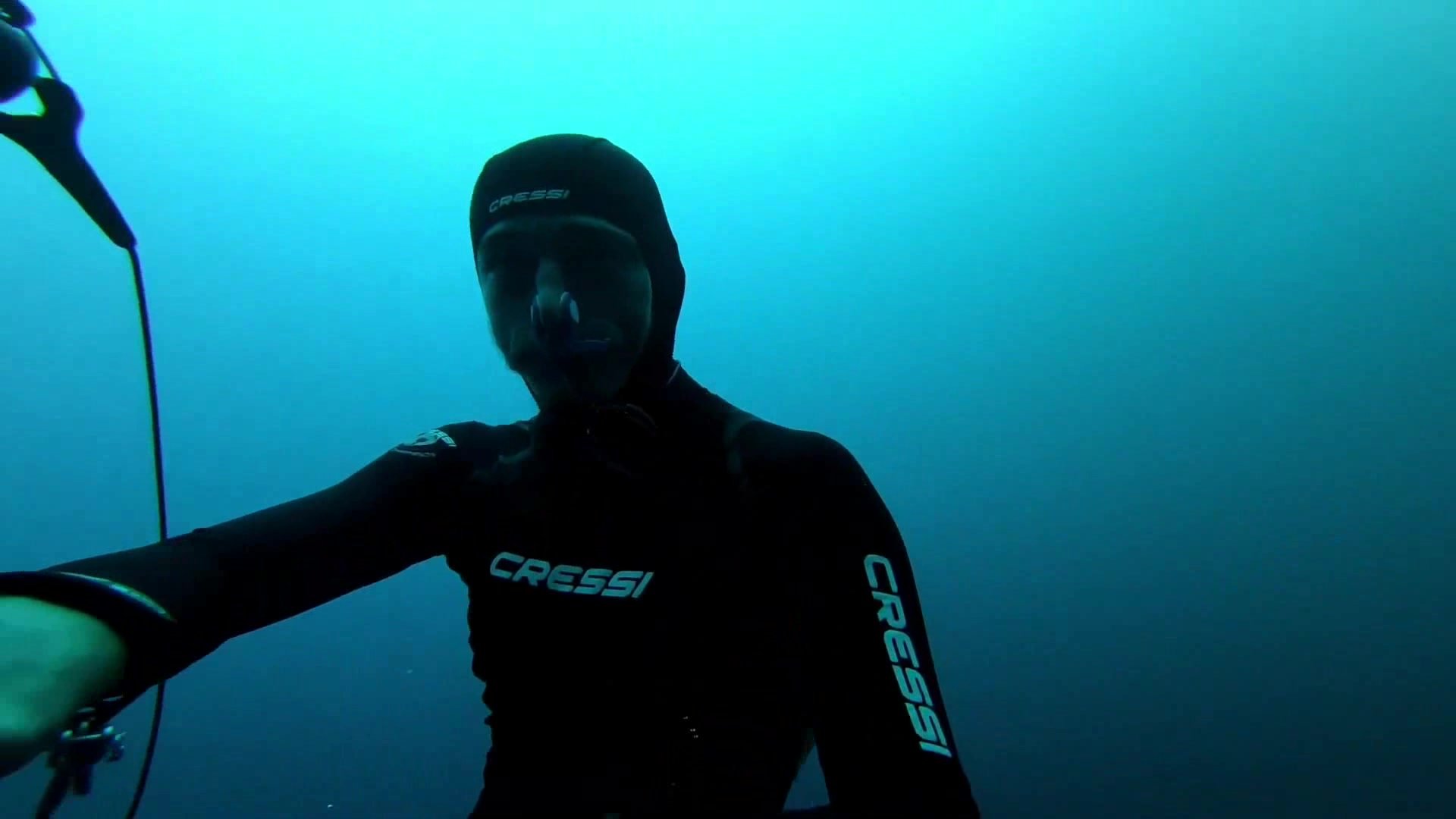 Underwater barefaced freediver in tight wetsuit - video 3