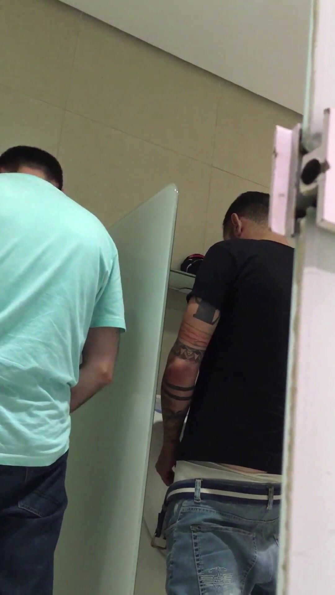 Two dudes playing in the urinals