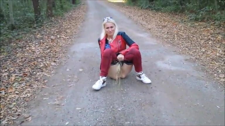 Woman pissing on the road