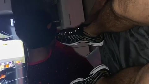 Slave licks sneakers