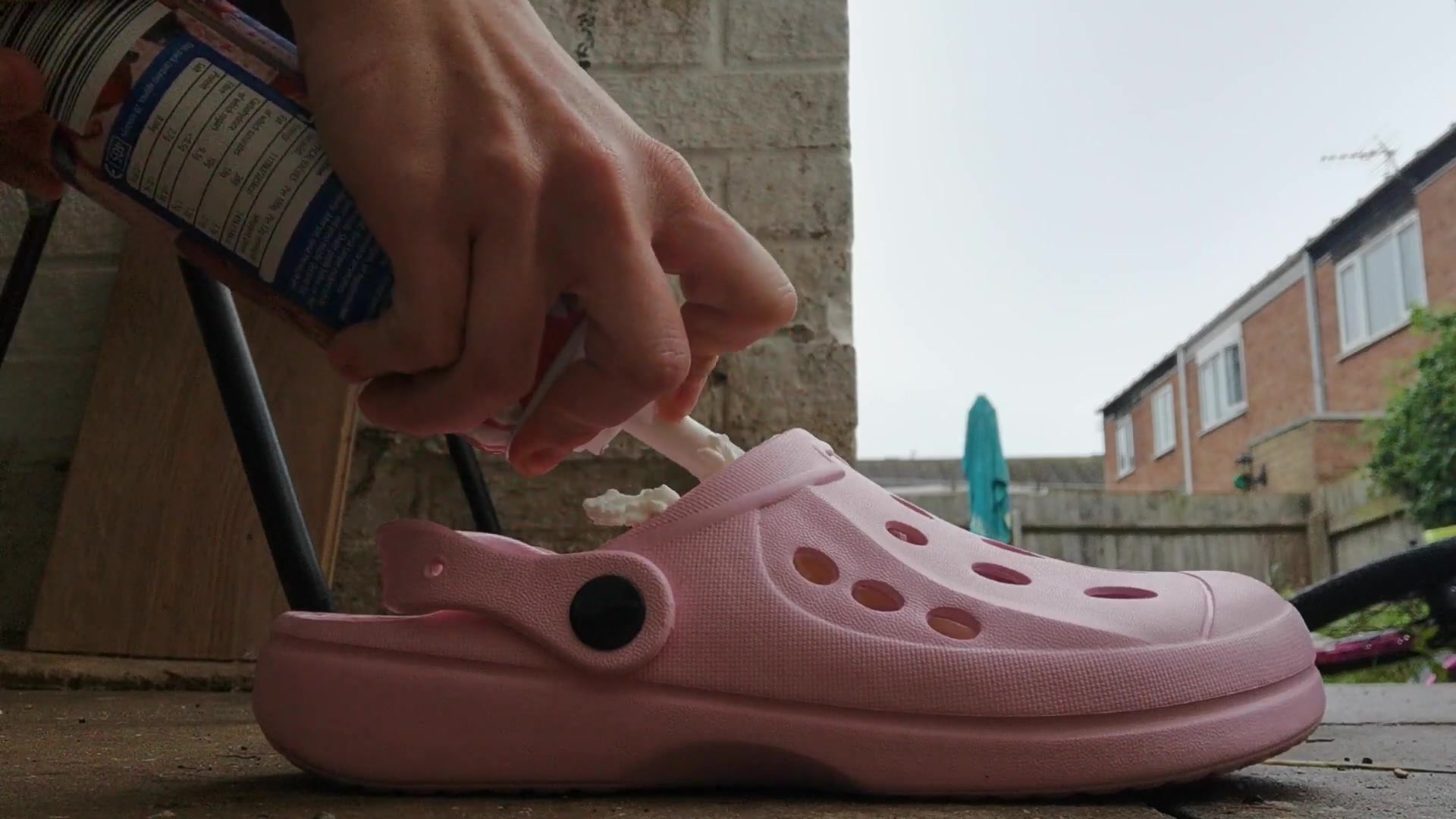 Girl putting cream into her shoes
