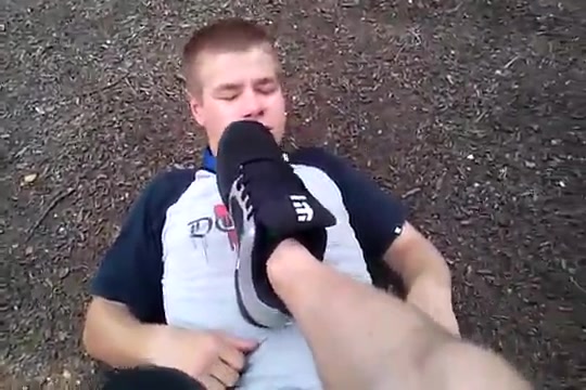 Slave sniffing socks and licking feet of his master