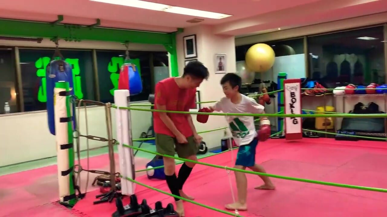 Two teen boy boxing training(gut punching)
