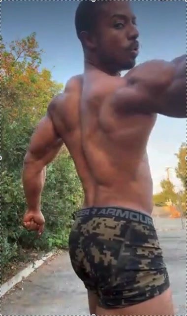 Black Muscle Master Flexes Outside