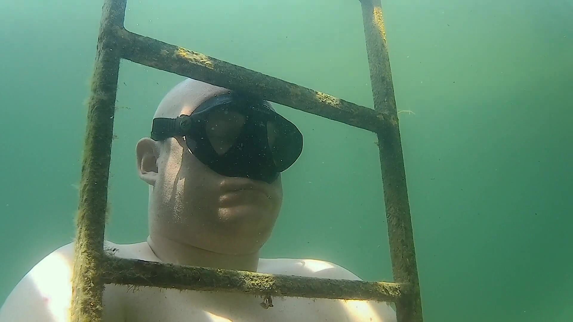 Beefy baldie breatholding underwater for three minutes