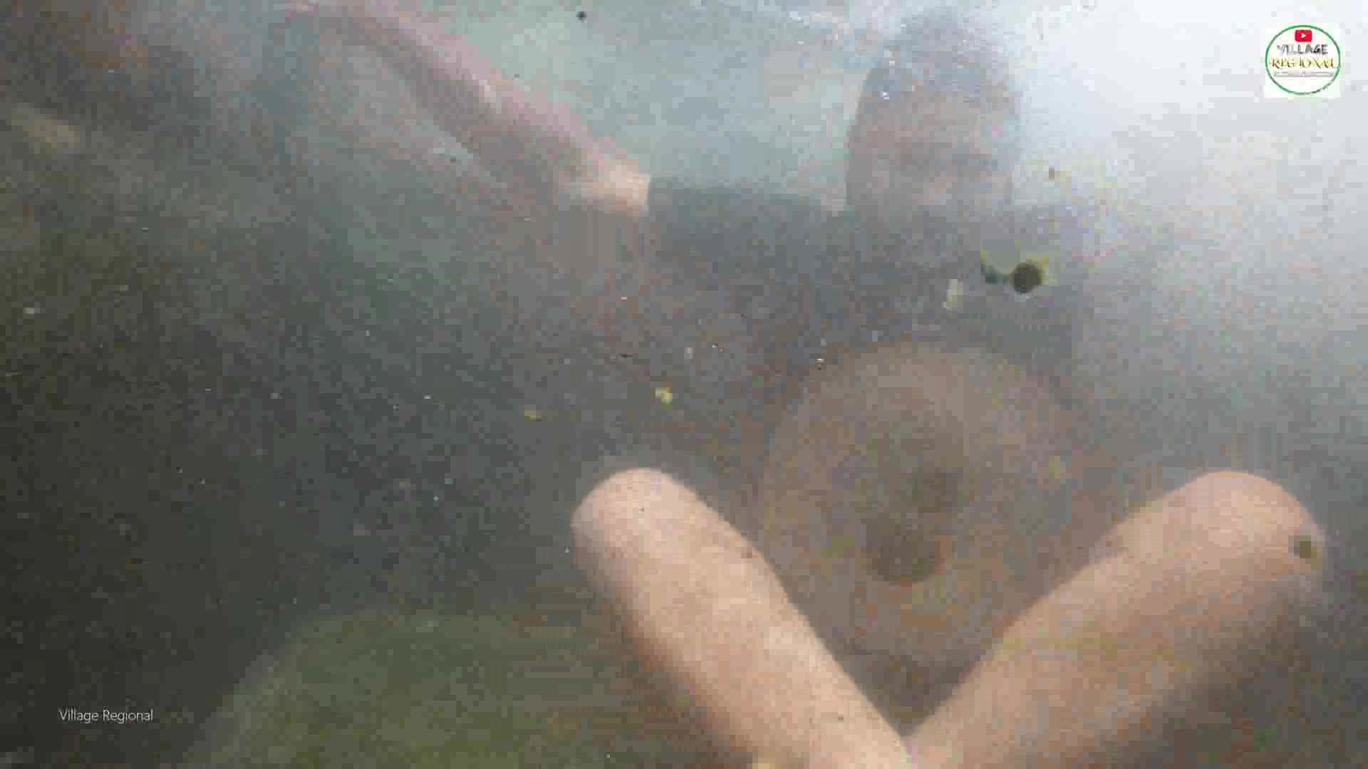 Clothed indian guy barefaced underwater