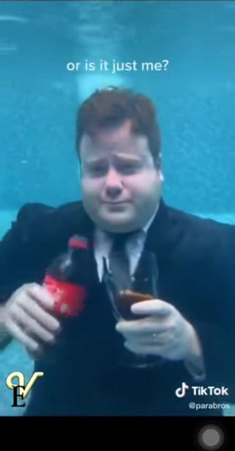 Beefy clothed guy drinking barefaced underwater