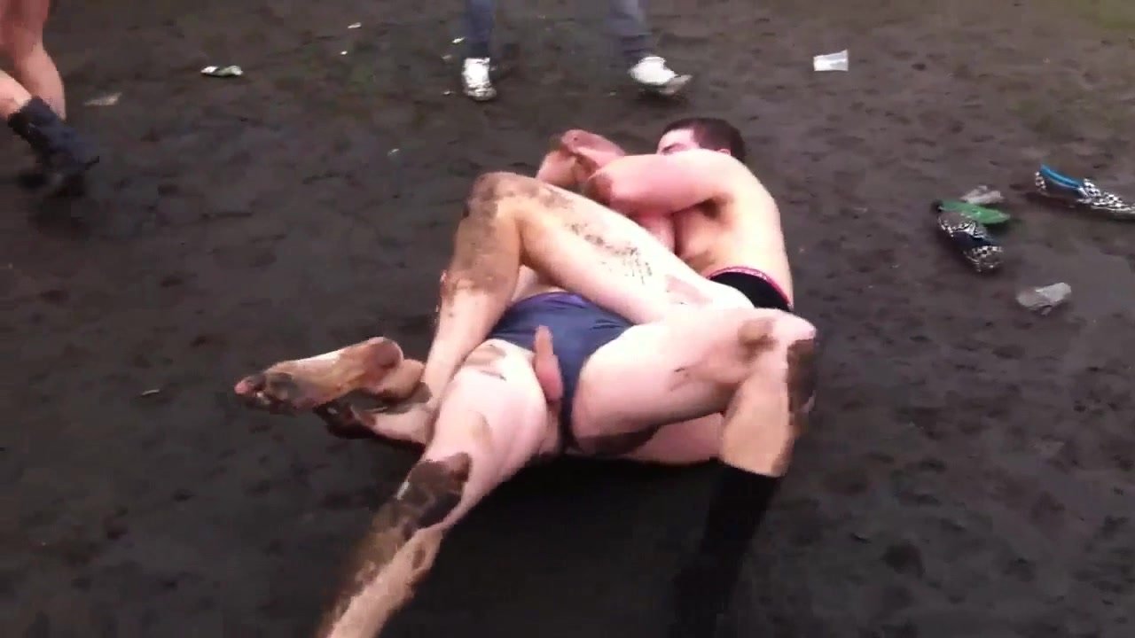 Two guys fighting naked for fun in the mud