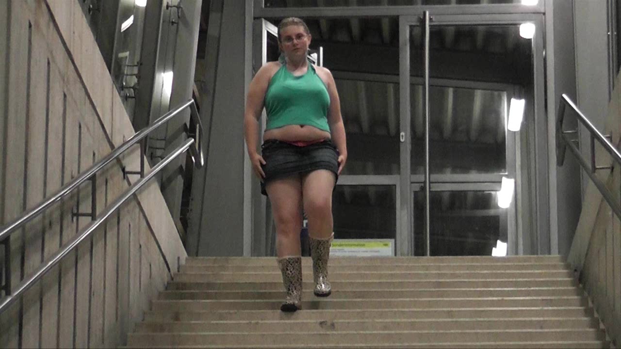 Girl flashing at train station and pissing on stairways