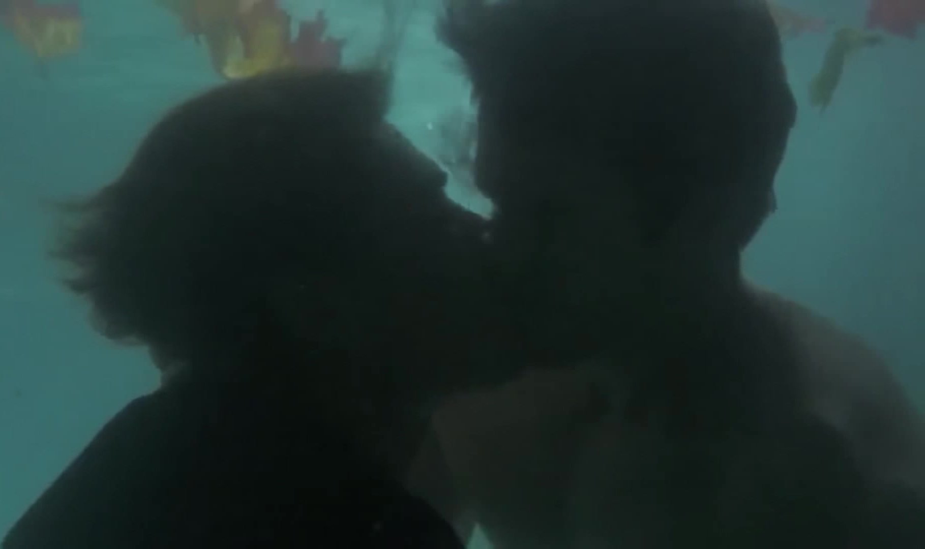 Underwater barefaced gay kiss in pool