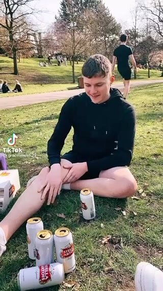 Lad pissing in a bag