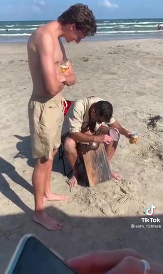 Cute guy pisses himself in the beach