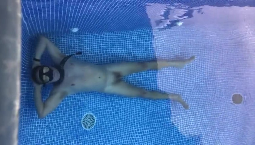 Naked underwater breathold in pool