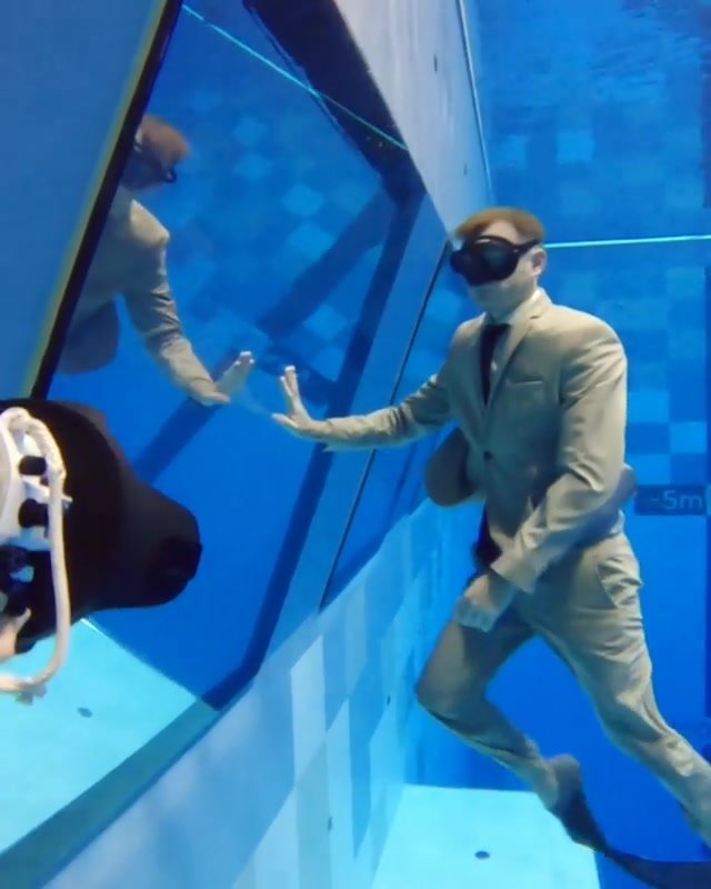 Fully clothed underwater in suit