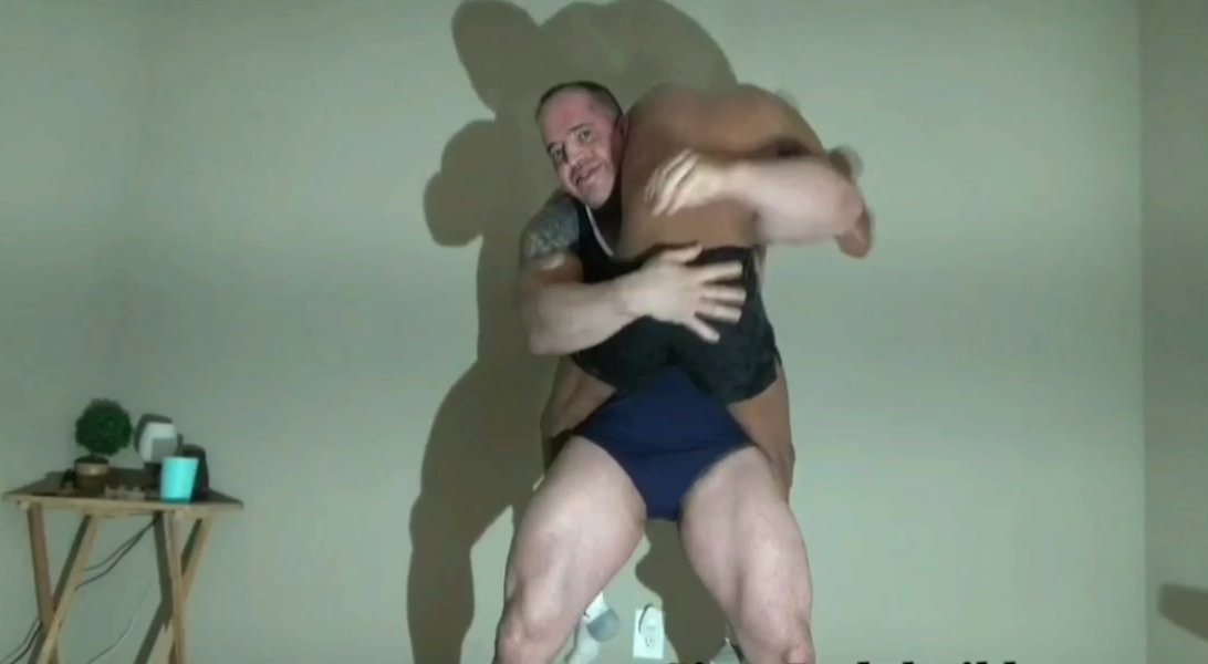 Huge bodybuilder crushing bearhug