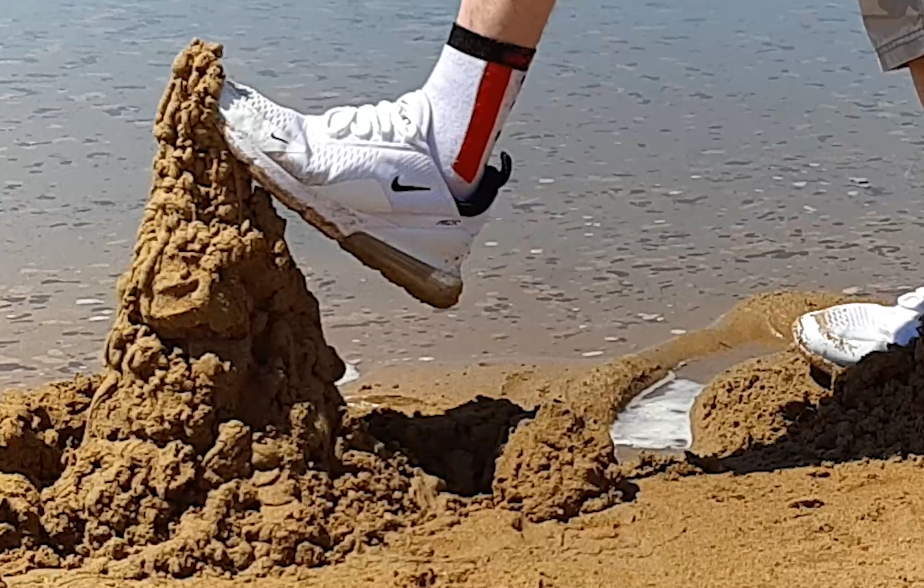 Destroing sand castels with nike sneakers