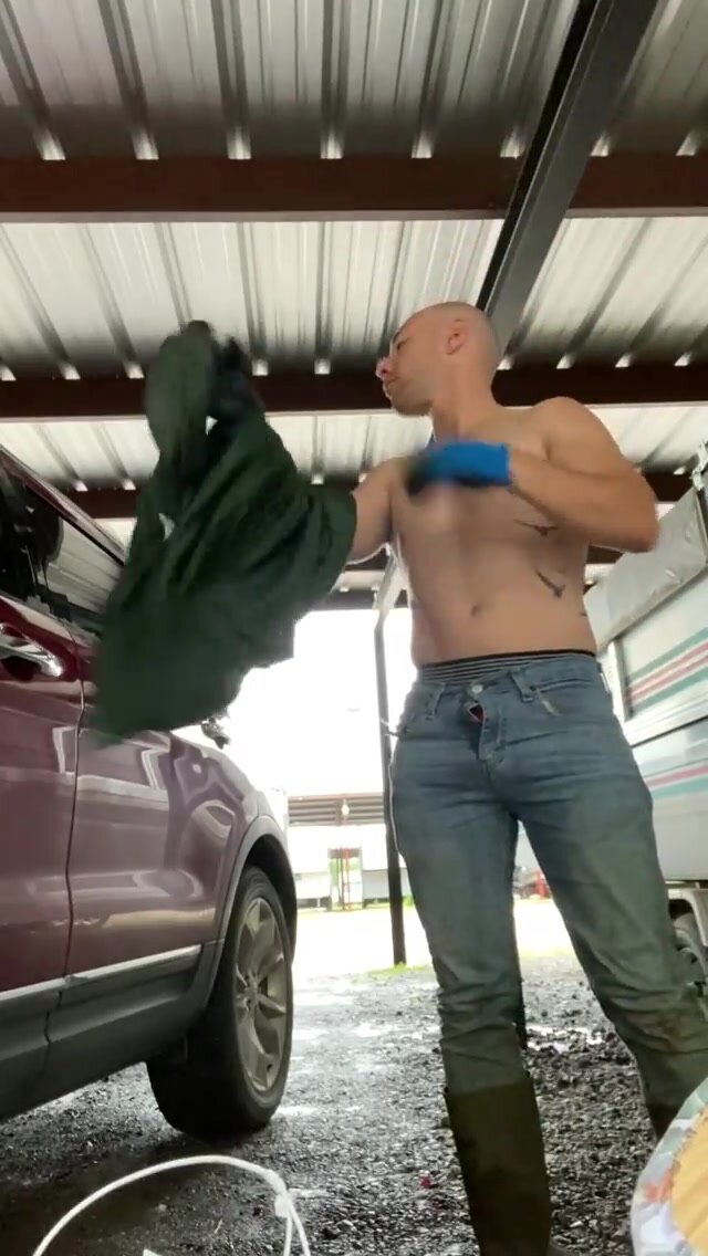 Asian guy pissing in a garage