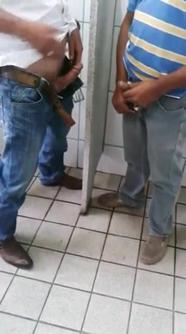 Two guys play in men's toilet