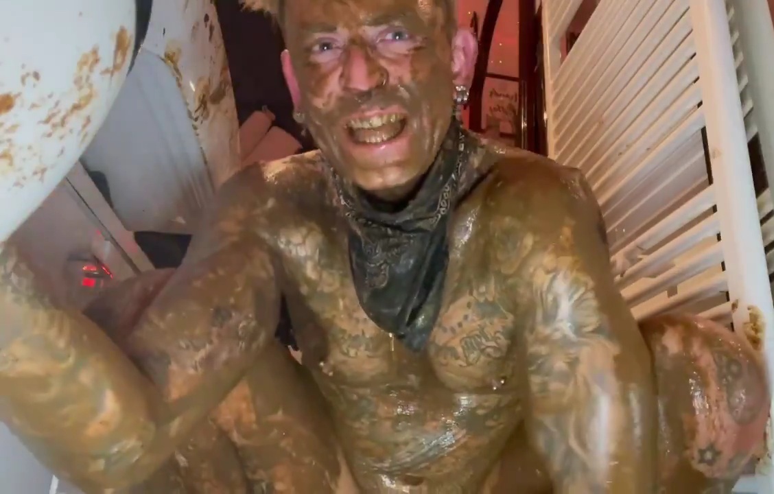 Tatted pig covered in shit