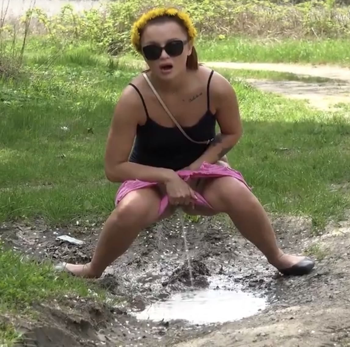 Desperate girl pees in puddle
