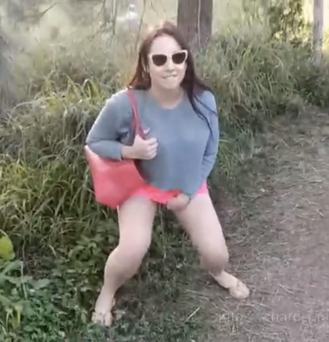 Woman takes a sneaky pee along the trail