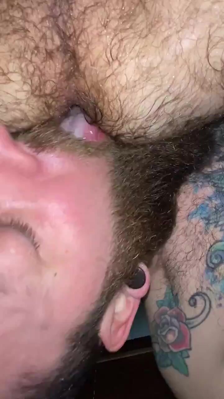 Bearded guy munches on a hairy hole