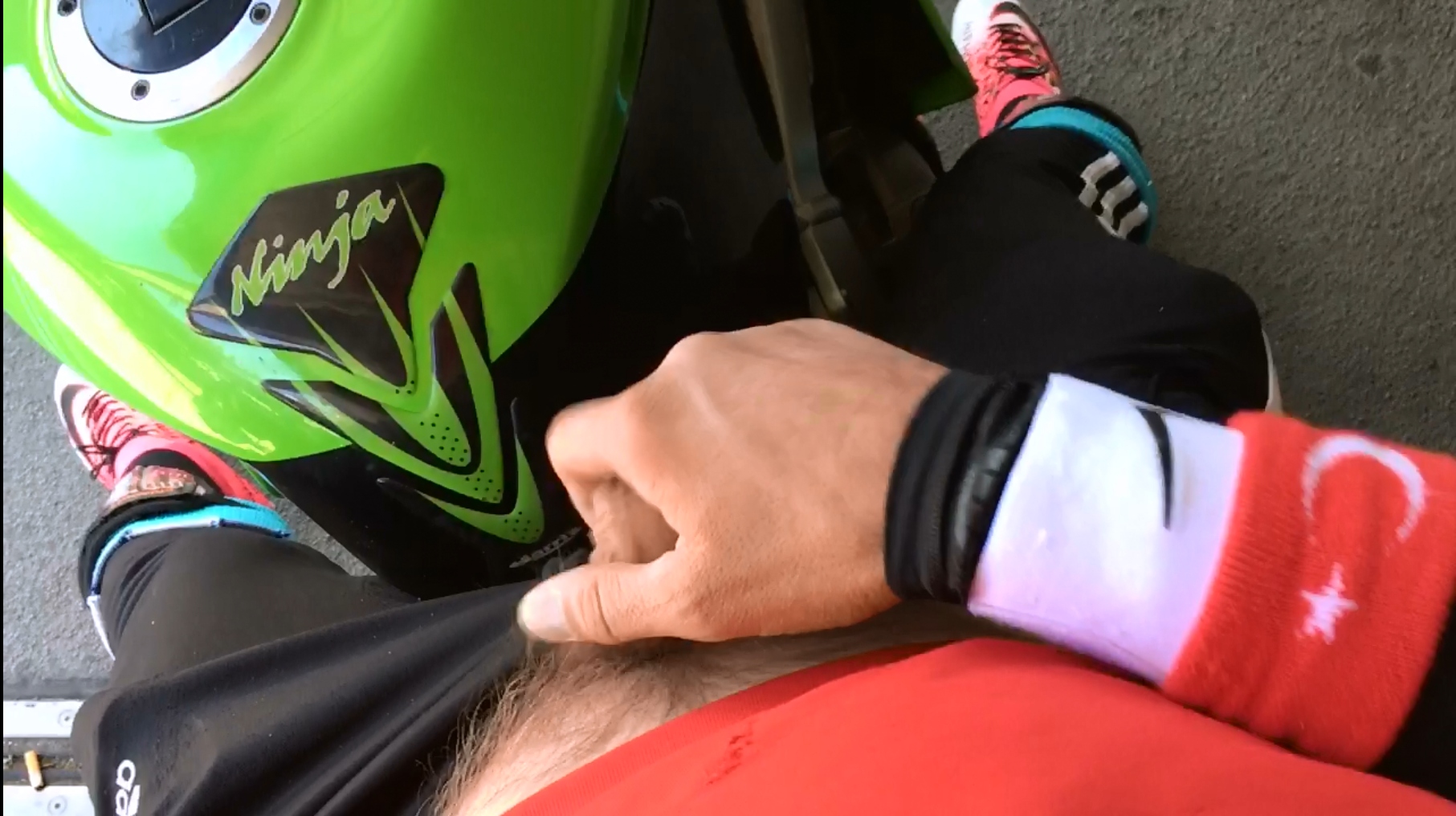 cummin in soccer gear over a Kawasaki Ninja racebike