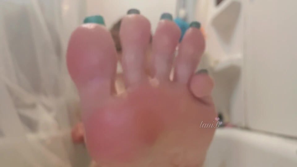 Asian woman teases her feet in bathtub