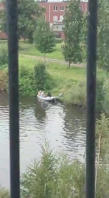 Girl peeing across the canal
