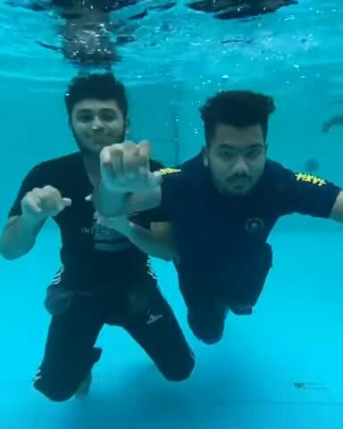 Indian buddies clothed and barefaced underwater