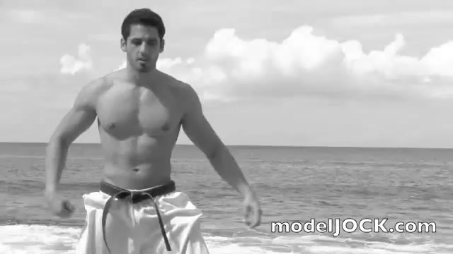 Merlin Muscular Male Model Does Karate on the Beach.mp4