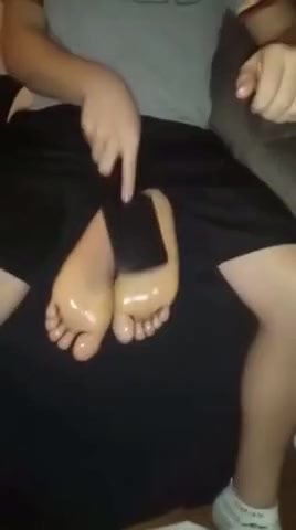 Boy tickles friends feet