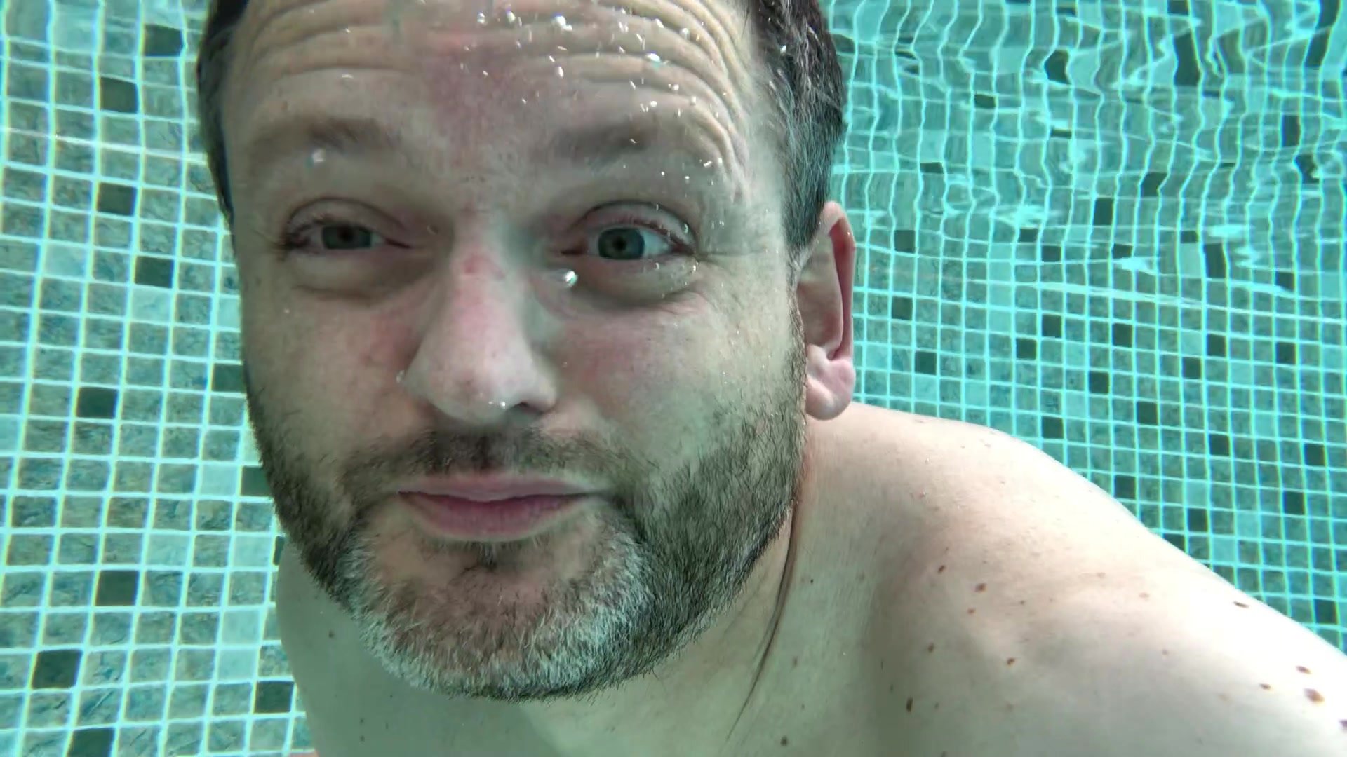 Barefaced bearded hottie blowing bubbles underwater