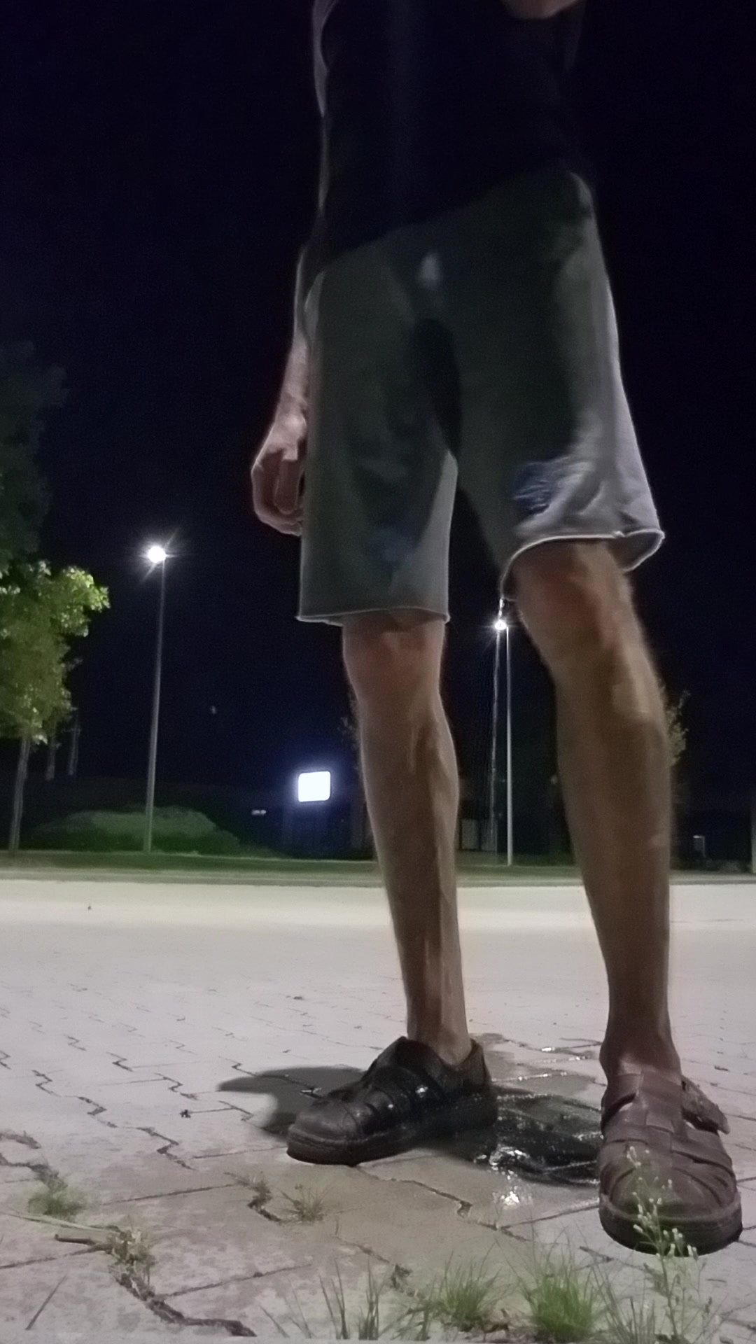 Piss in shorts in the night on a parking spot