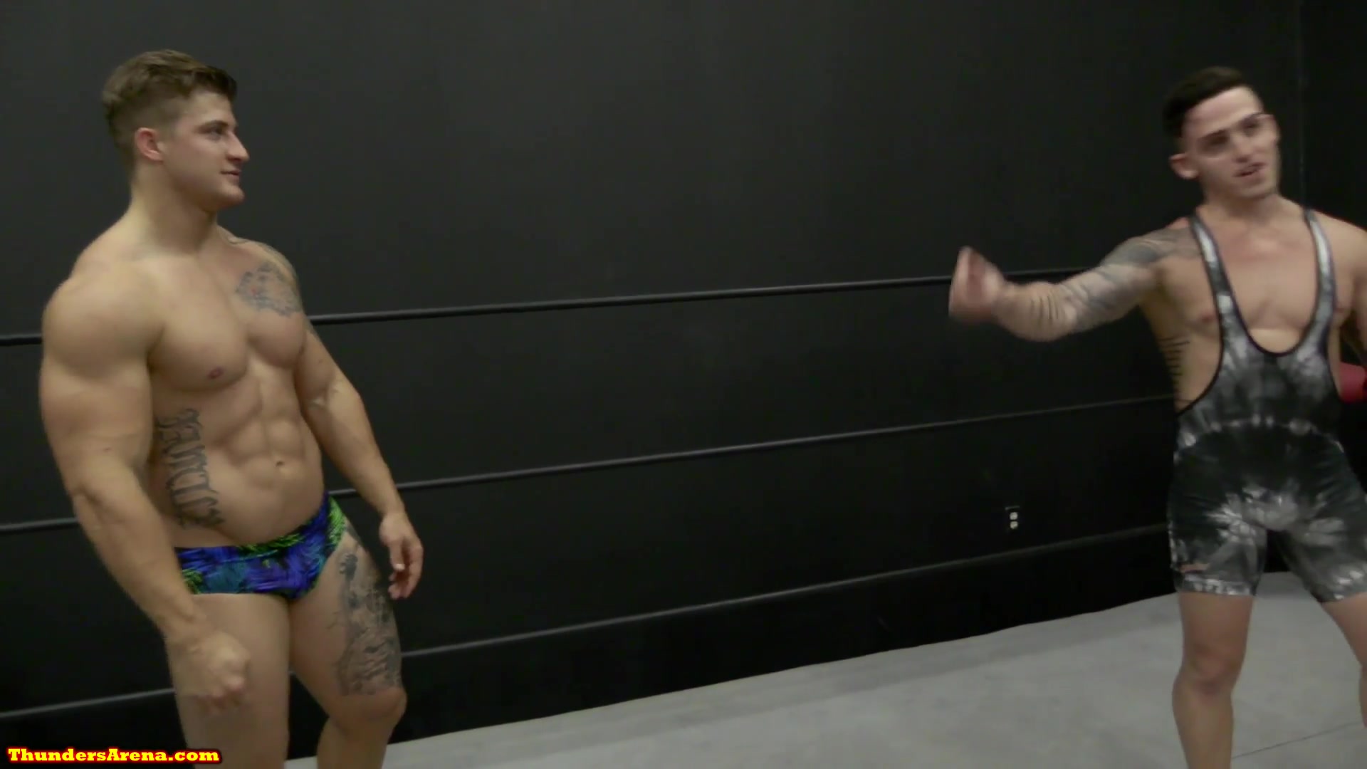Two muscle studs wrestling, gut punching and low blows. 