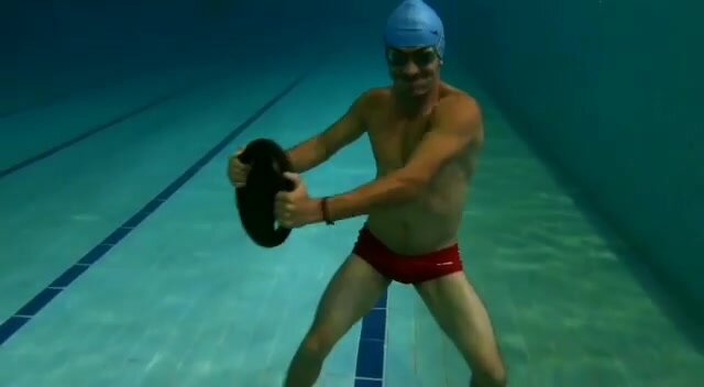 Goofing underwater in red speedo