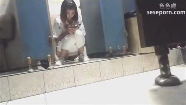 Girl with upset stomach poops in a doorless toilet