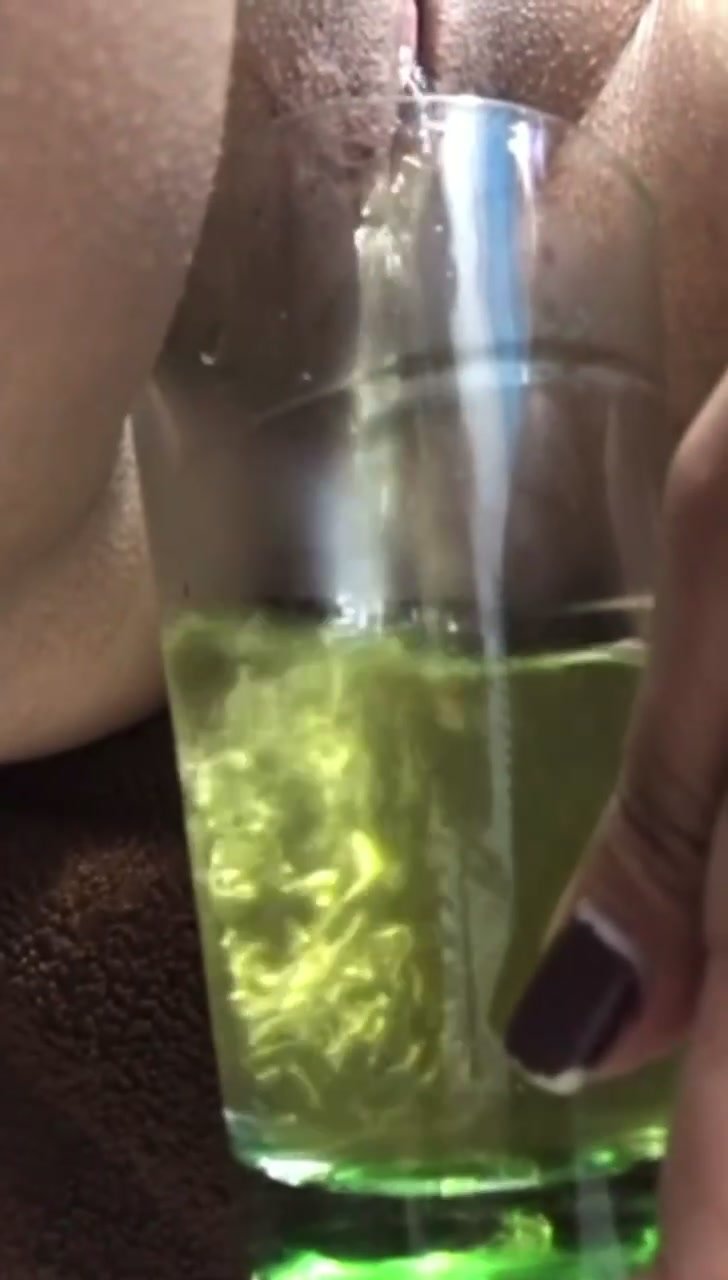 Woman Fills a Glass with Golden Yellow Pee