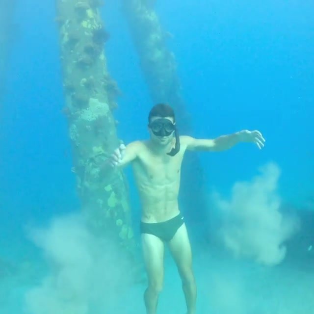Underwater freediver in black speedo