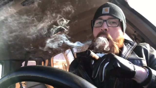Hot ginger cigar smoker in car