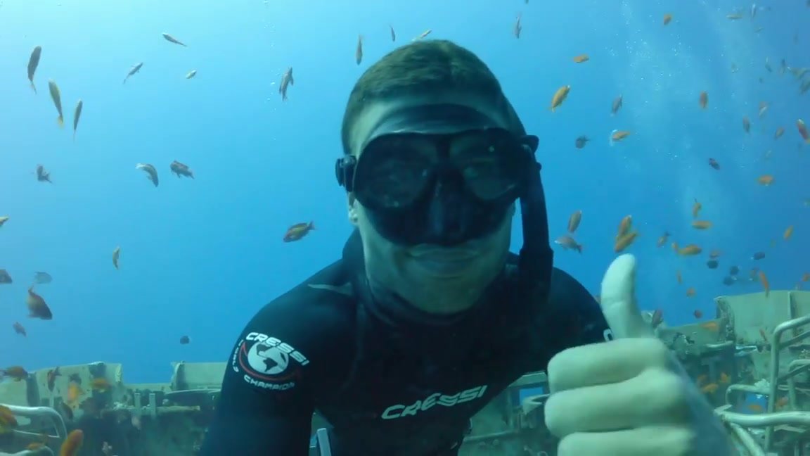 Underwater freediver in wetsuit breatholding