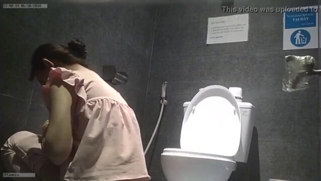 Woman pees on floor next to toilet