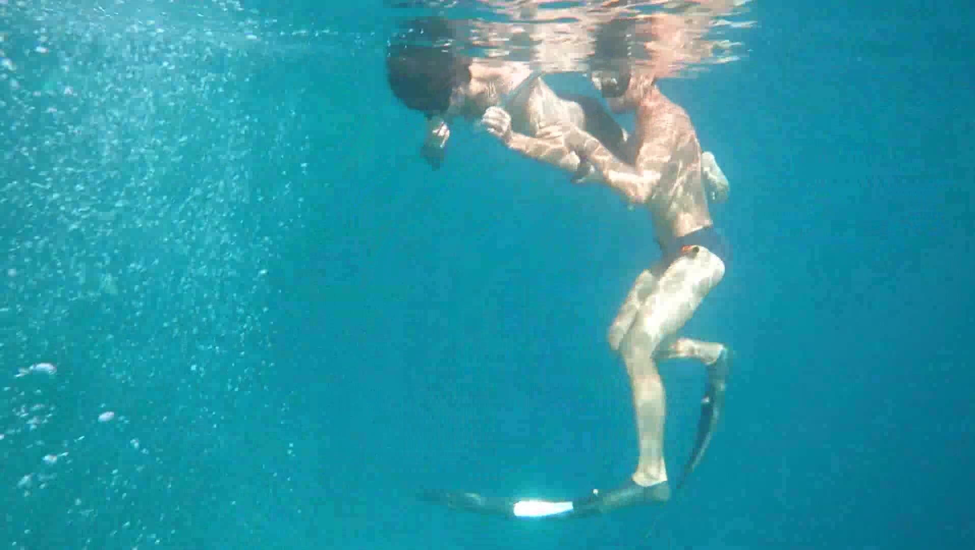 Freedivers underwater in tight speedos