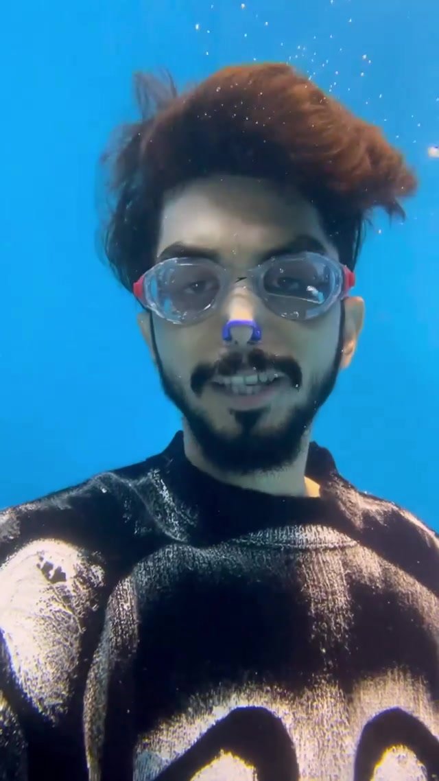 Indian talking underwater with clear goggles