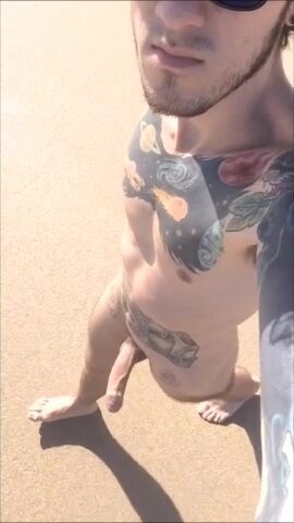 Tattooed Guy Takes Naked Stroll on Beach
