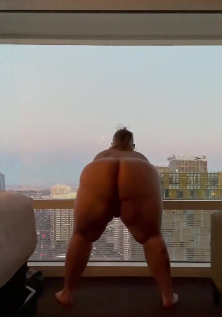 Guy spanks his own HUGE ass on balcony