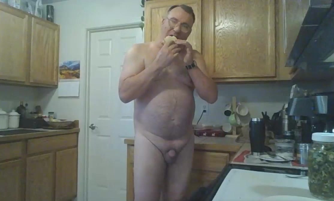 Naked daddy enjoys a sandwich