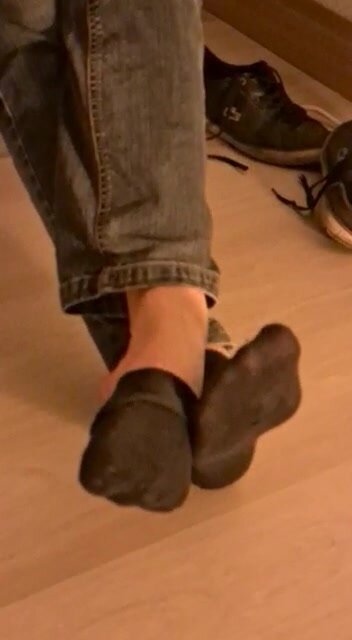Boy shows his smelly socks and feet