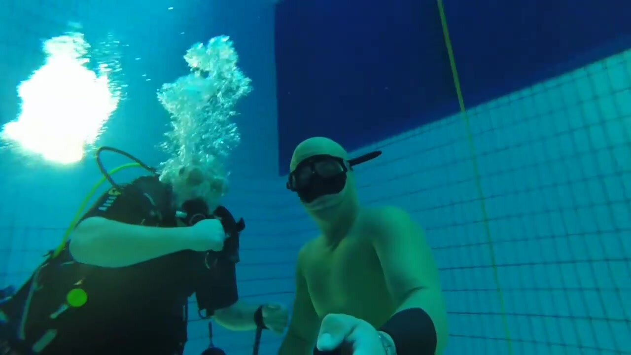 Freediving deep underwater in tight wetsuit
